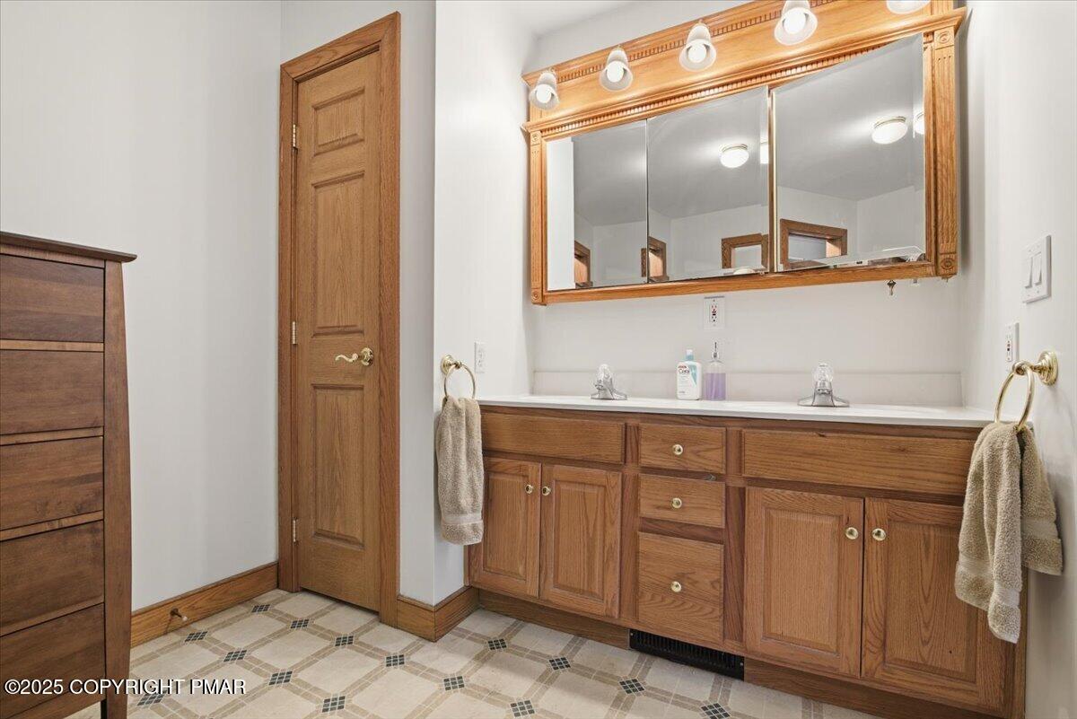 563 Pensyl Creek Road Stroudsburg, PA 18360 - Photo 36 of 143 a bathroom with a granite countertop sink mirror and vanity