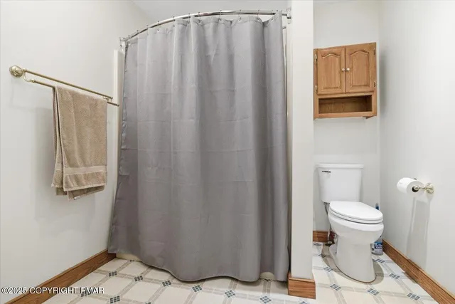 a view of a house with a wooden deck and a yard