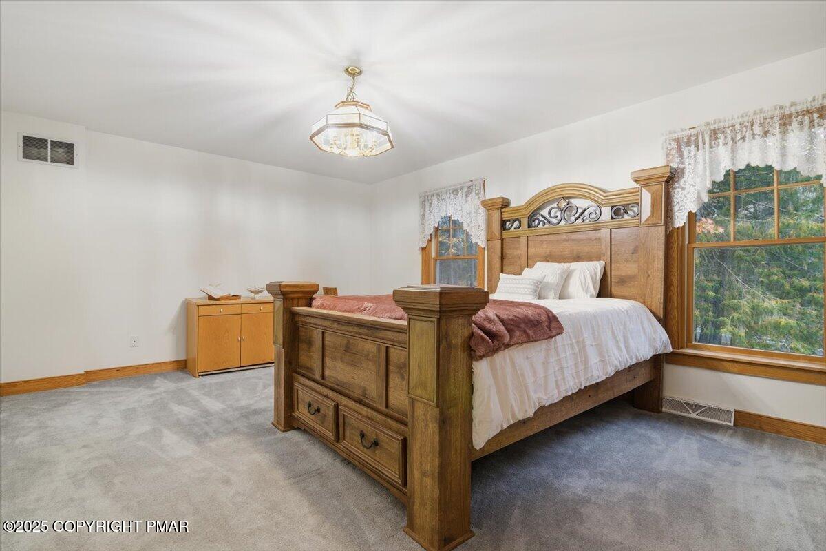 563 Pensyl Creek Road Stroudsburg, PA 18360 - Photo 43 of 143 a bedroom with a bed and a table