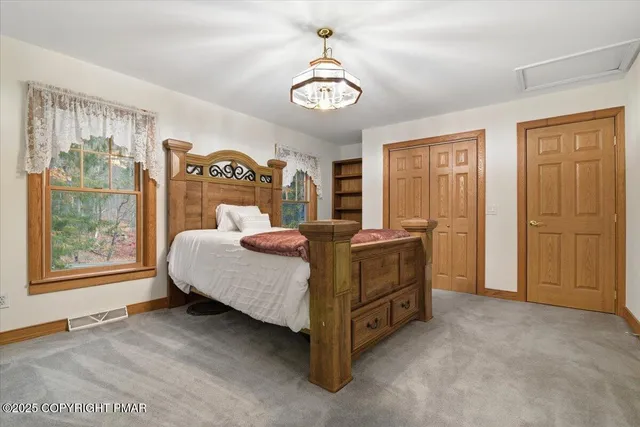 a front view of a house with a tree