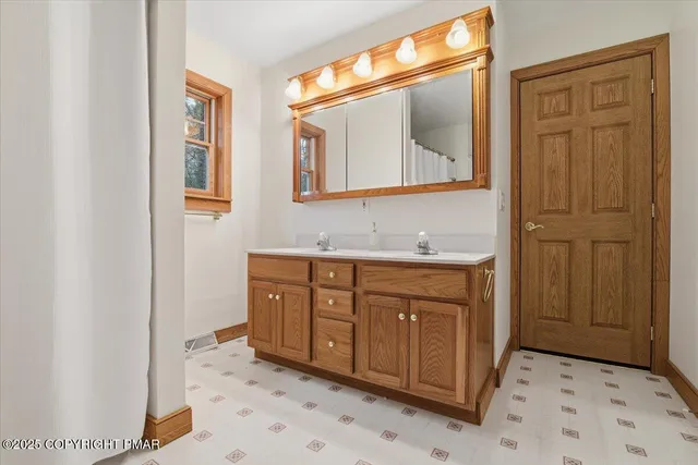 a front view of house with yard and trees around