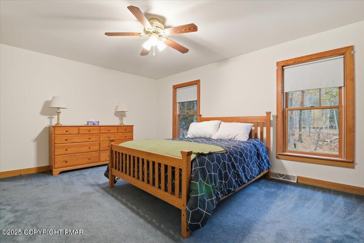 563 Pensyl Creek Road Stroudsburg, PA 18360 - Photo 55 of 143 a bed sitting in a bedroom next to a window