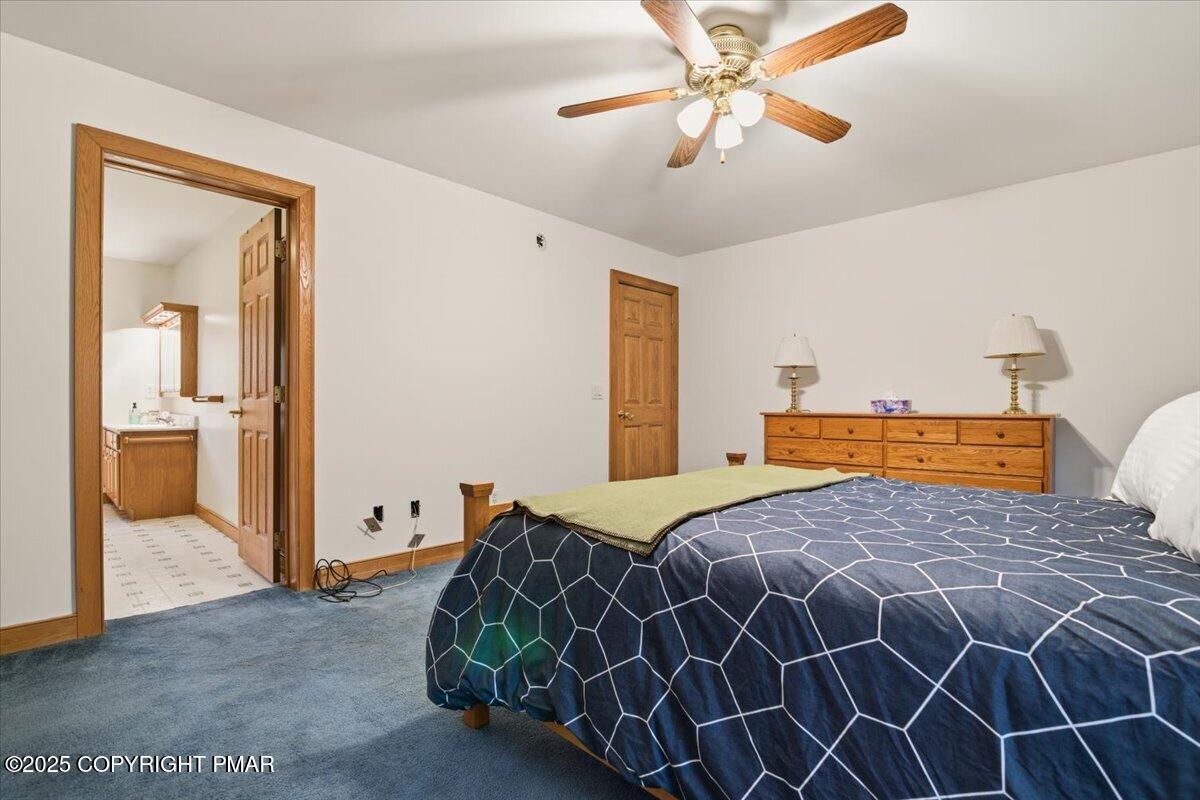 563 Pensyl Creek Road Stroudsburg, PA 18360 - Photo 57 of 143 a bedroom with a large bed and a chandelier