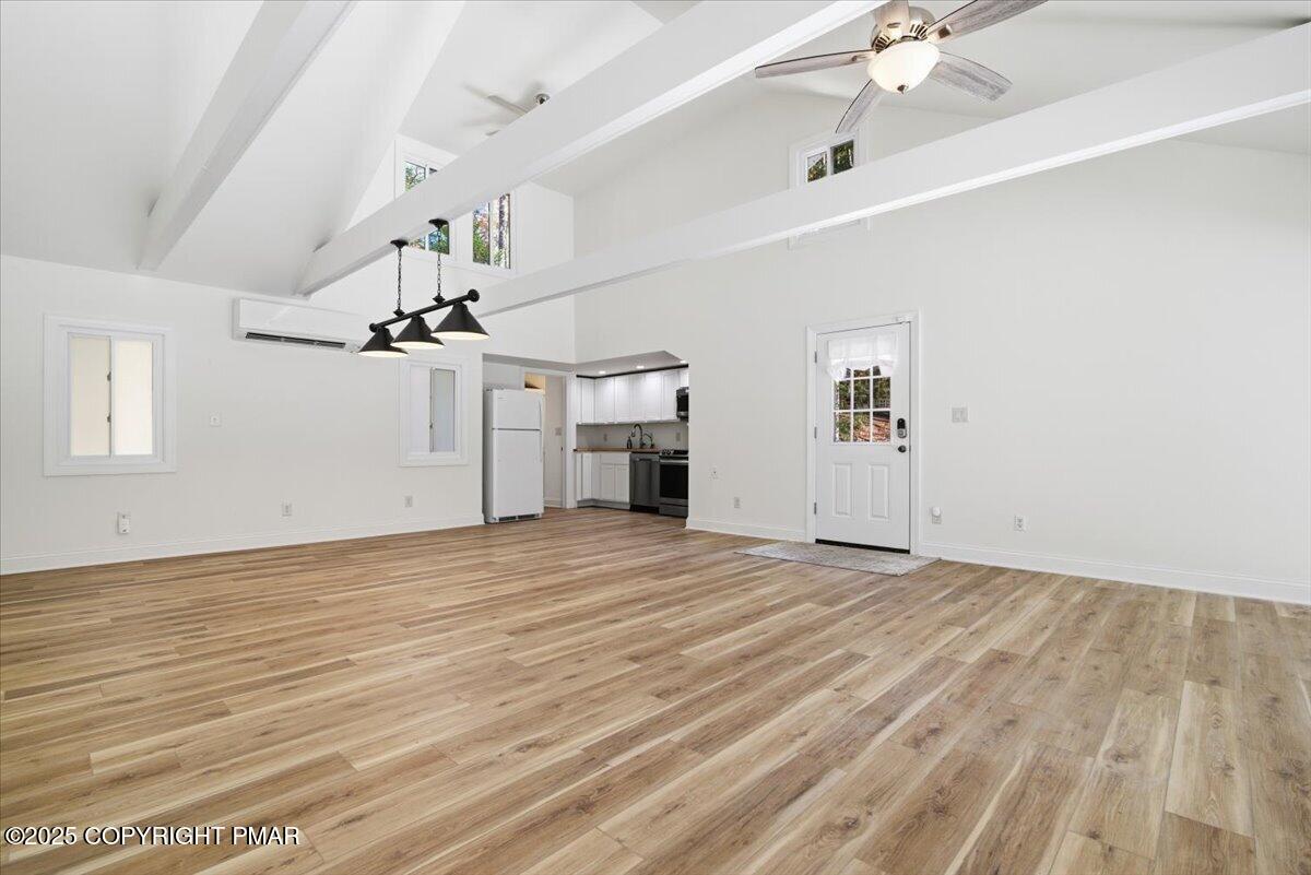 563 Pensyl Creek Road Stroudsburg, PA 18360 - Photo 87 of 143 a view of empty room with wooden floor and ceiling fan