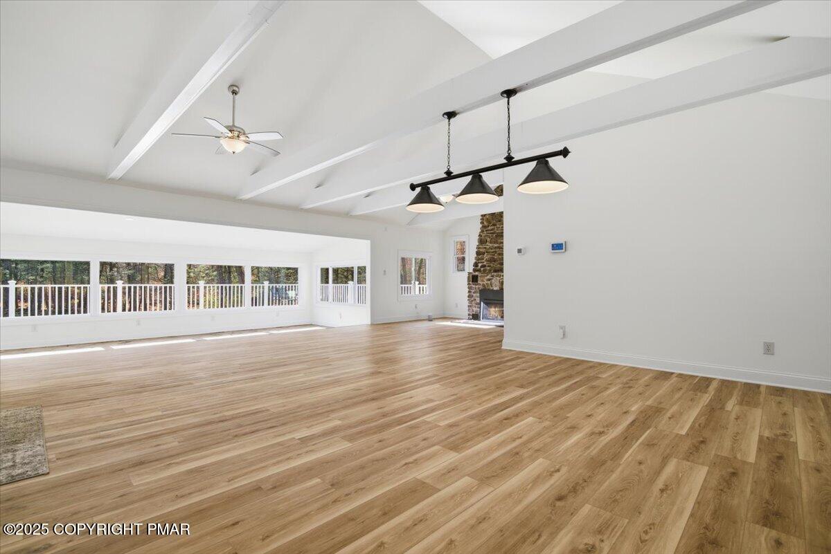 563 Pensyl Creek Road Stroudsburg, PA 18360 - Photo 88 of 143 a view of an empty room with wooden floor ceiling fan and windows