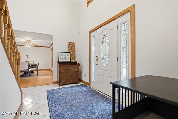 a kitchen with stainless steel appliances granite countertop wooden cabinets a sink a stove a dining table and chairs