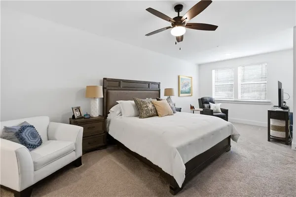 a spacious bedroom with a bed and a couch