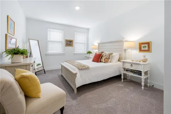 a bedroom with furniture and a large window