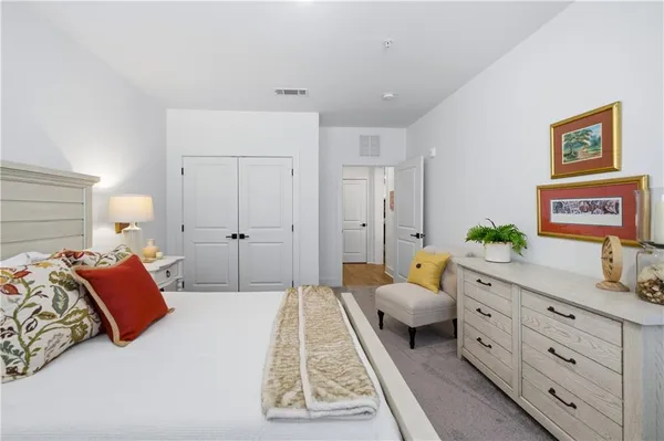 a spacious bedroom with a bed and a couch