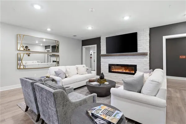 a living room with furniture fireplace and a flat screen tv