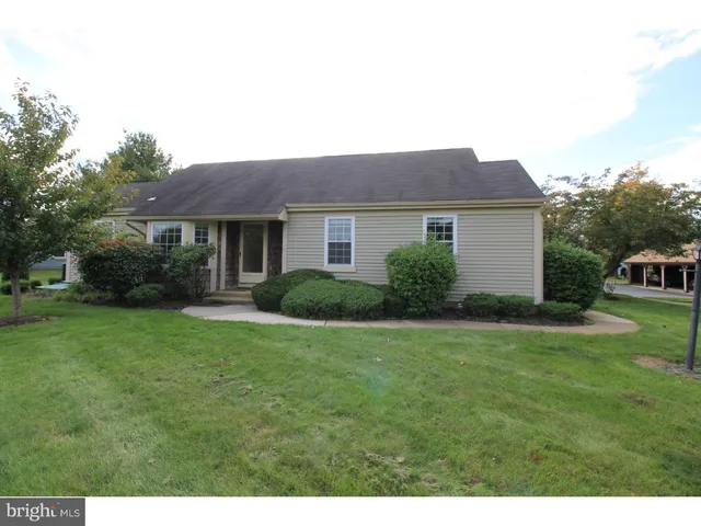a front view of house with a garden