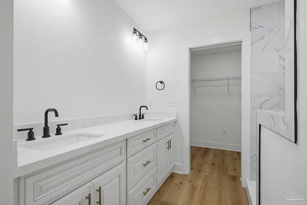 a bathroom with a double vanity sink and mirror