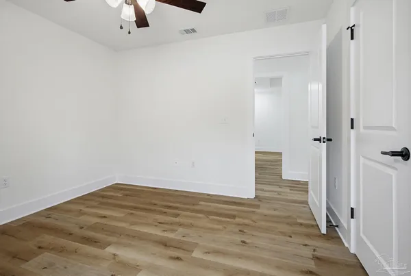 a view of a room with wooden floor