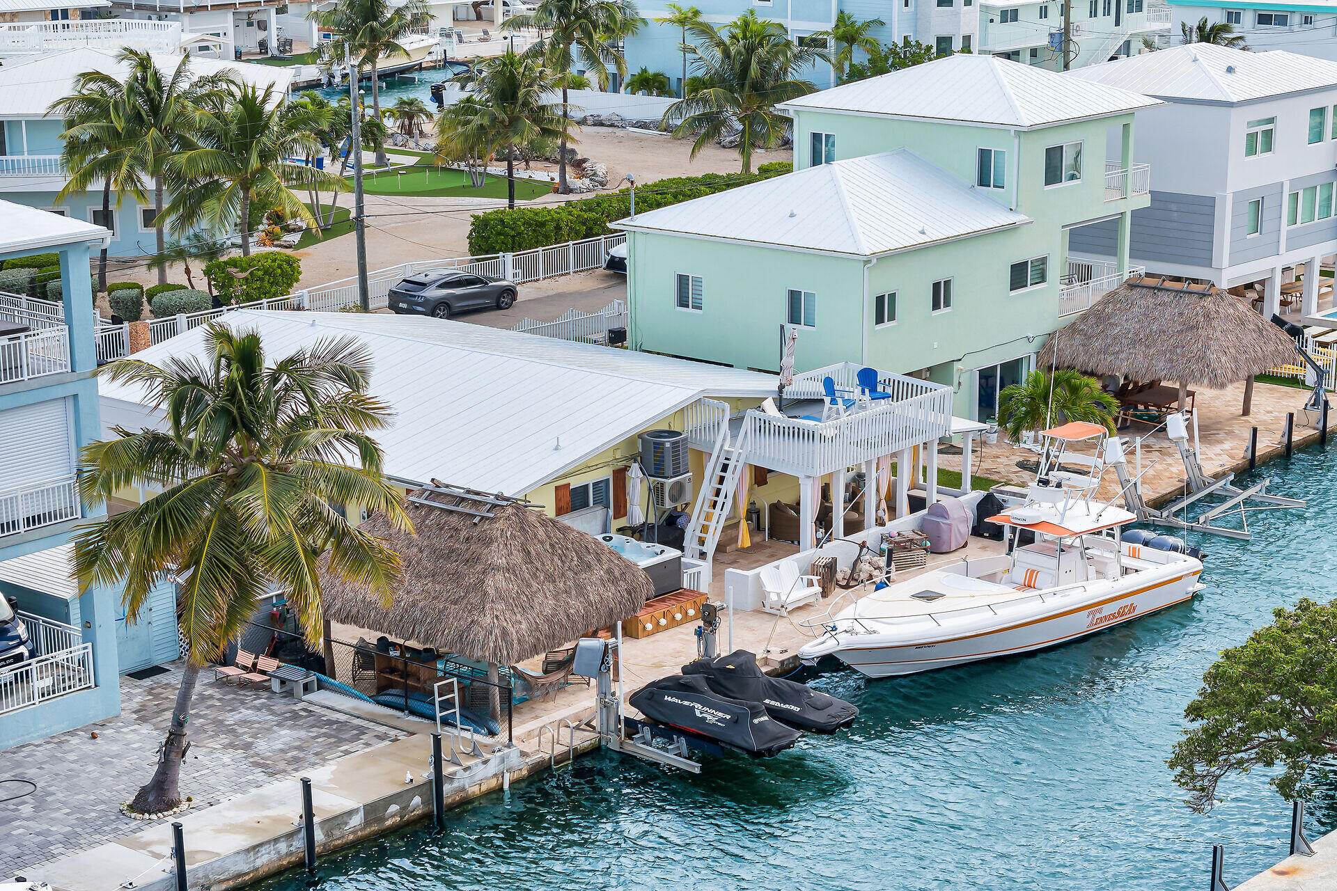 712 Grouper Lane Key Largo, FL 33037 - Photo 20 of 42 a view of a house with patio furniture and a garden