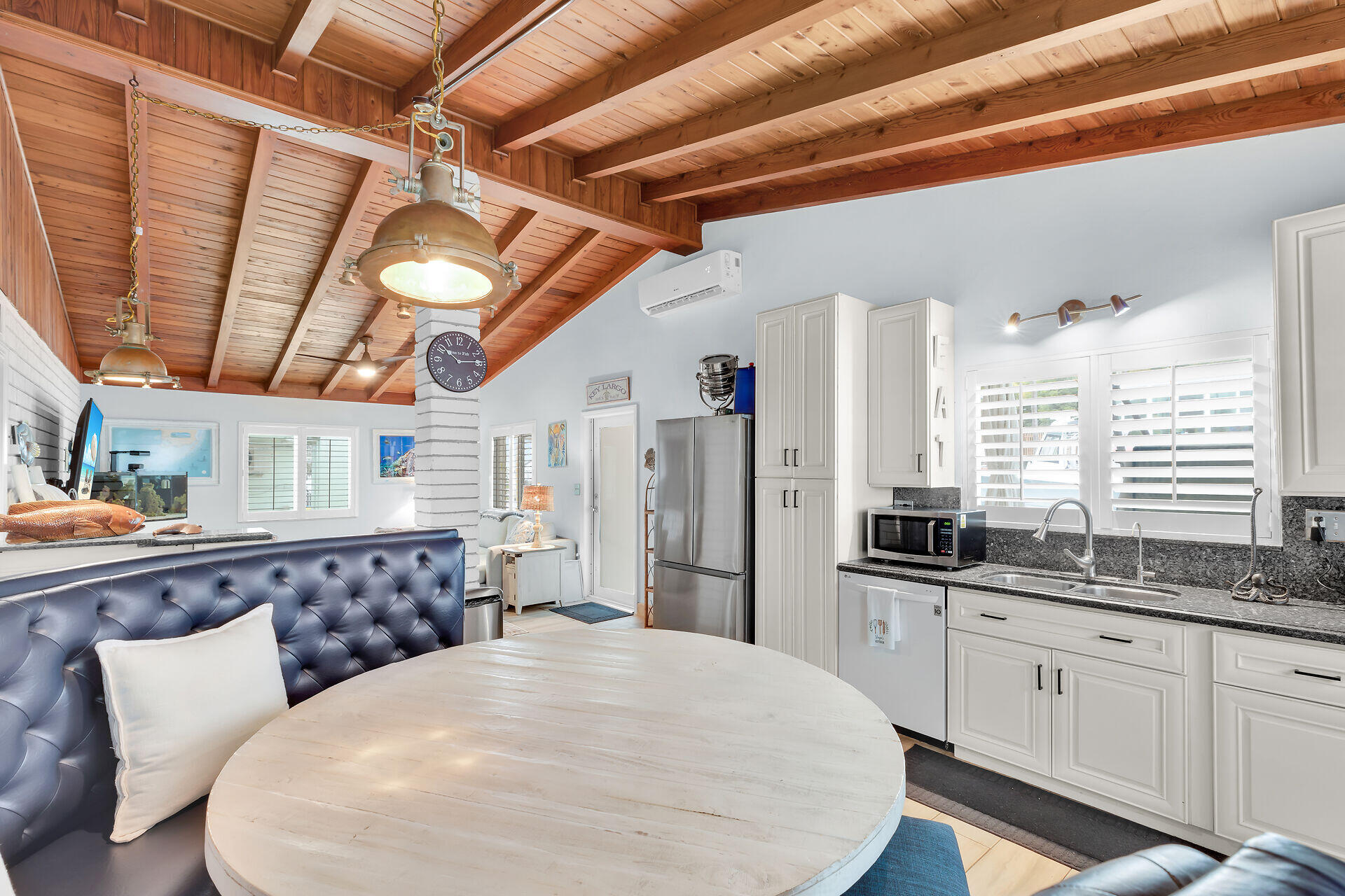 712 Grouper Lane Key Largo, FL 33037 - Photo 8 of 42 a kitchen with stainless steel appliances kitchen island granite countertop a table chairs in it and wooden floors