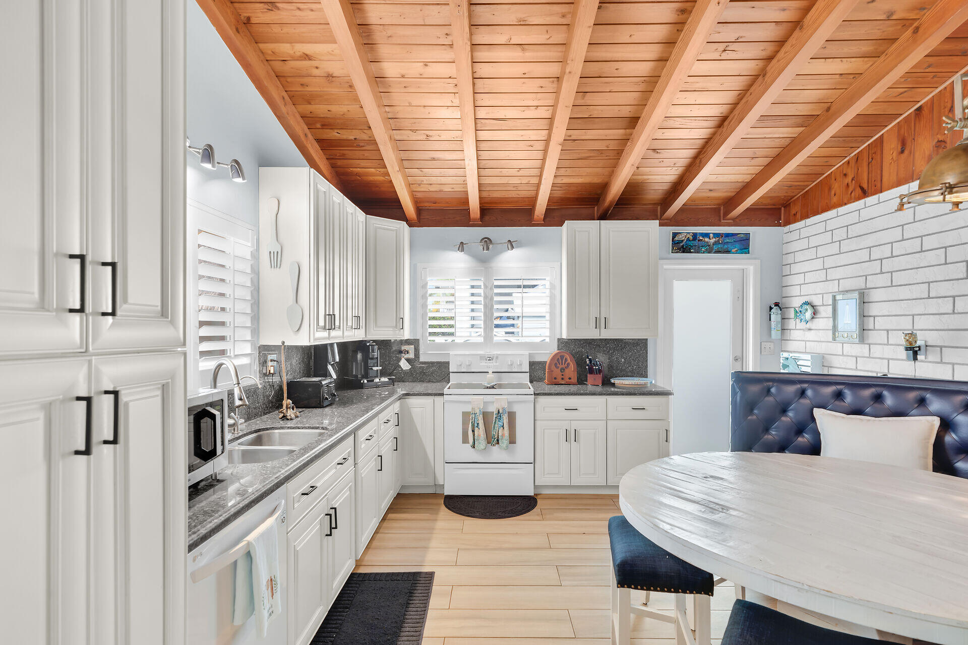 712 Grouper Lane Key Largo, FL 33037 - Photo 10 of 42 a kitchen with a sink a stove a refrigerator and cabinets