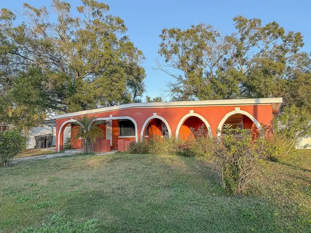 a view of a yard with large trees