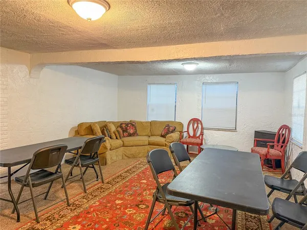 a living room with furniture and a lamp
