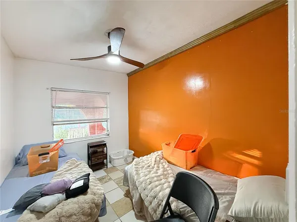 a bedroom with furniture and a window