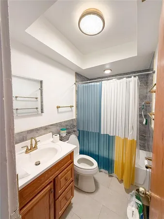 a bathroom with a sink mirror vanity and toilet