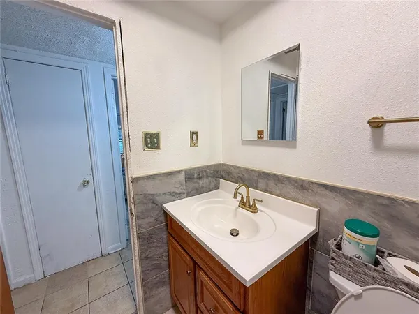 a bathroom with a sink a mirror and a toilet