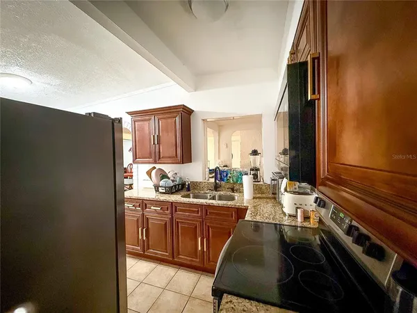 a kitchen with a sink stove and cabinets