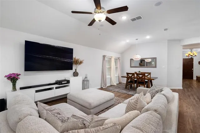 a bedroom with furniture and a flat screen tv