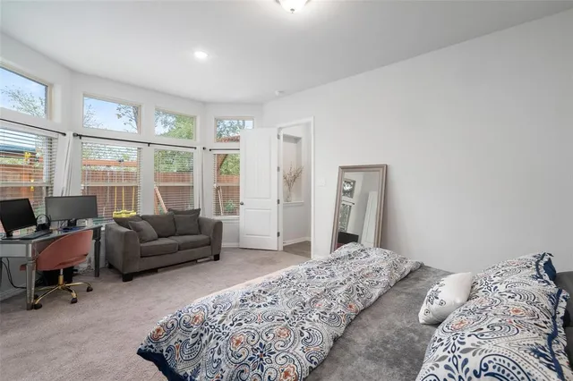 a bedroom with a bed and glass window