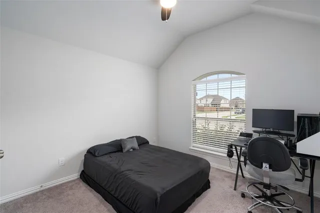 a bed sitting in a room next to a window