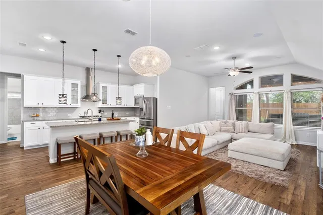 a living room with stainless steel appliances kitchen island granite countertop furniture and a large window