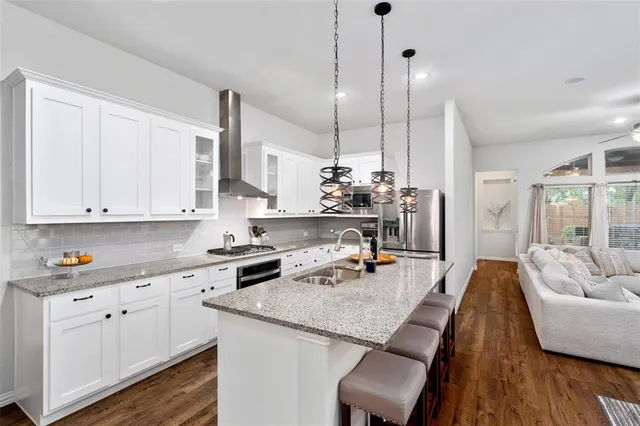 a kitchen with sink cabinets and living room view