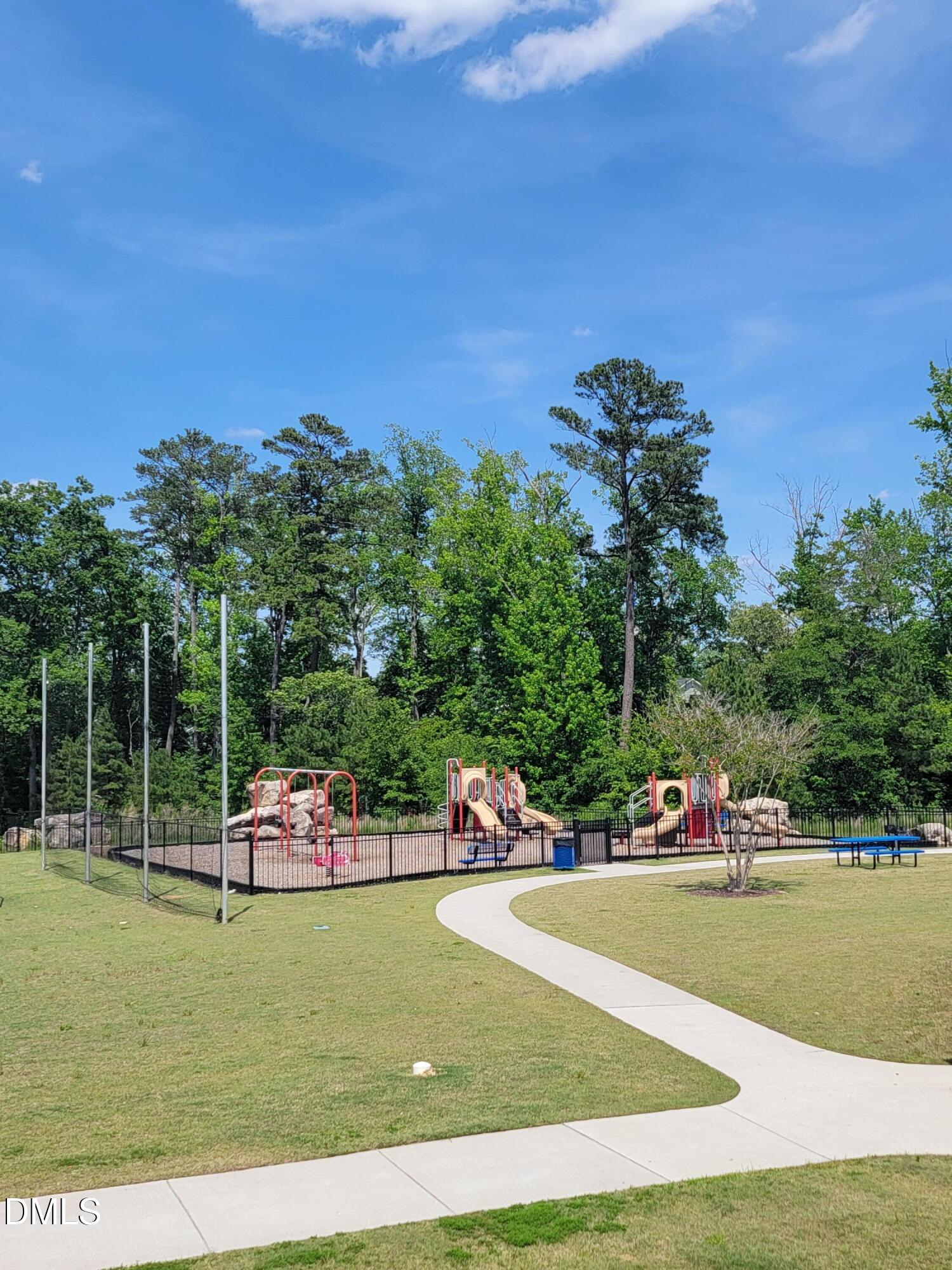 5046 Arkose Drive Raleigh, NC 27610 - Photo 27 of 33 a park view with a bench and trees in the background