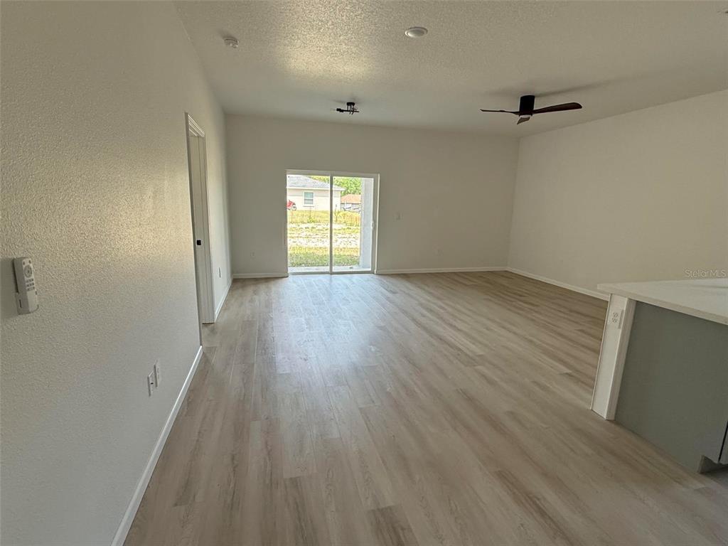 14685 Southwest 22nd Place Ocala, FL 34481 - Photo 4 of 13 an empty room with wooden floor and windows