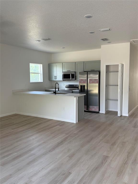 14685 Southwest 22nd Place Ocala, FL 34481 - Photo 5 of 13 a view of kitchen with wooden floor and electronic appliances