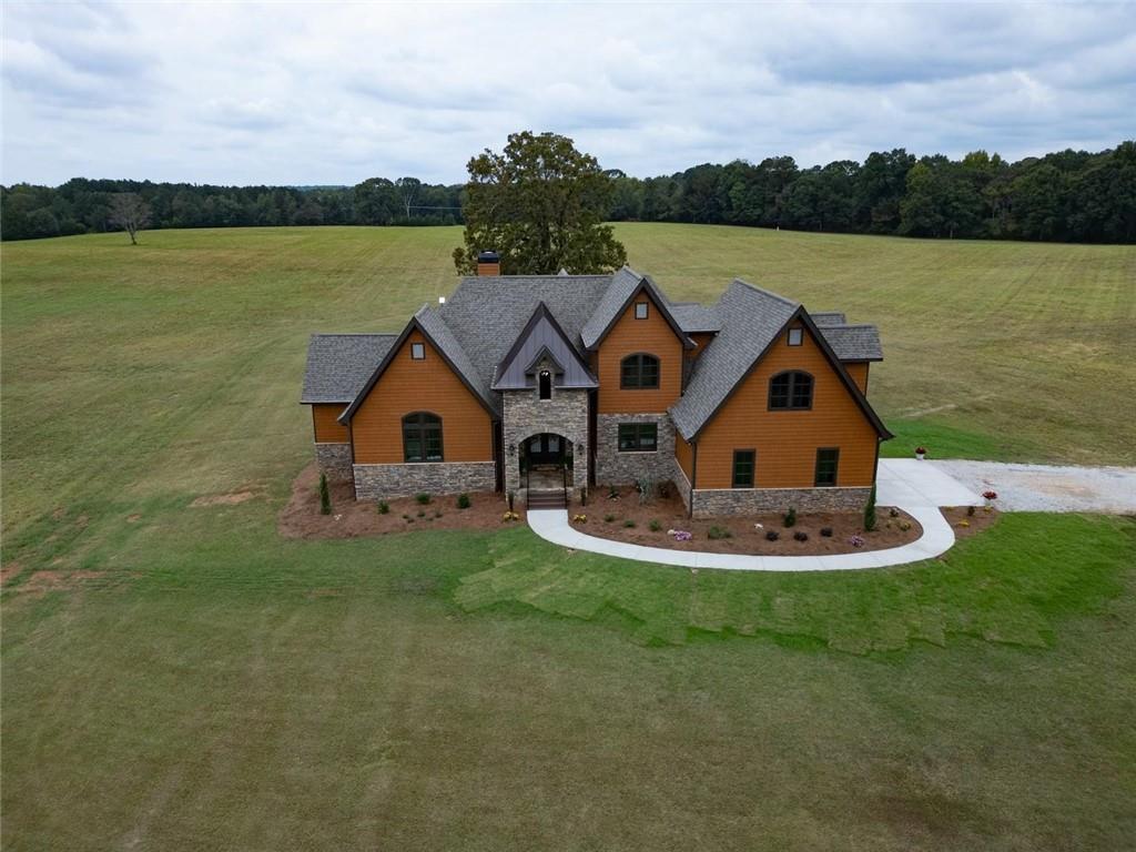 a aerial view of a house with a yard and lake view