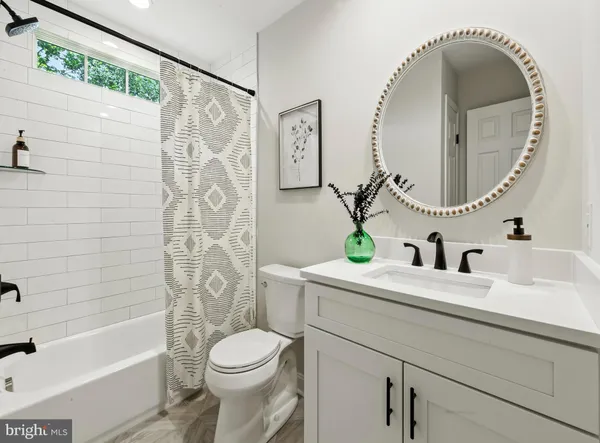 a bathroom with a sink mirror toilet and bathtub