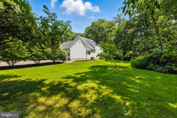 a view of a house with a yard and sitting area