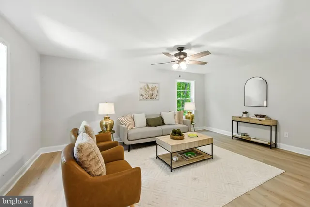 a living room with furniture a rug and a chandelier