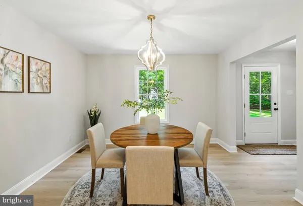 a dining room with furniture and window