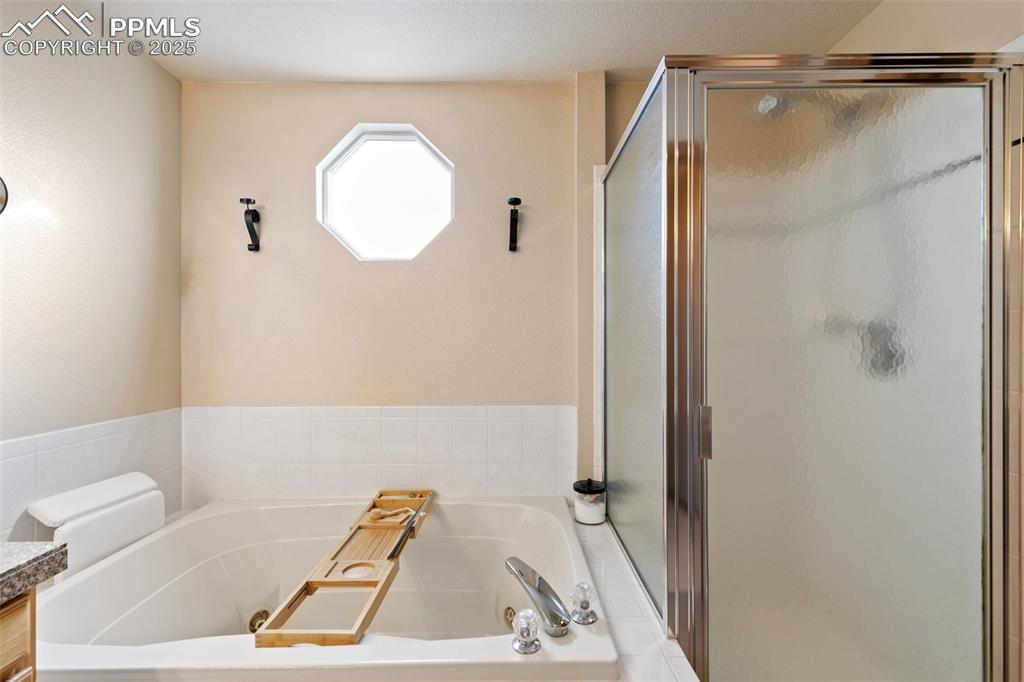 8518 Bohleen Road Peyton, CO 80831 - Photo 19 of 44 a bathroom with a tub and a shower