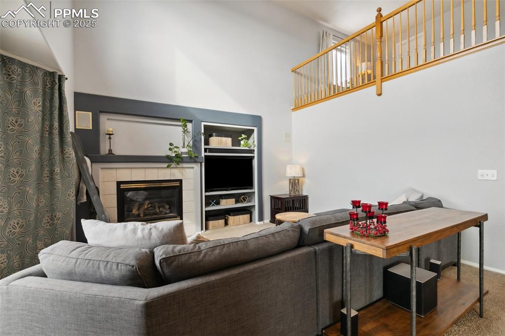 8518 Bohleen Road Peyton, CO 80831 - Photo 20 of 44 a living room with furniture a flat screen tv and a fireplace