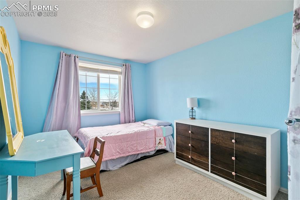 8518 Bohleen Road Peyton, CO 80831 - Photo 25 of 44 a bedroom with a bed and a dresser