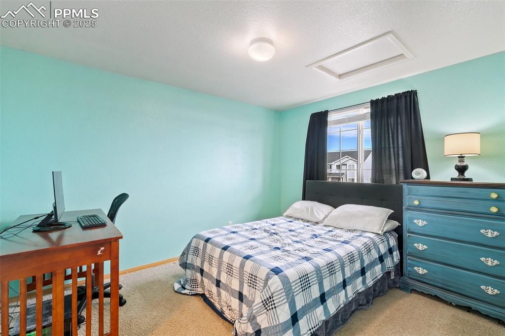 8518 Bohleen Road Peyton, CO 80831 - Photo 26 of 44 a bedroom with a bed and a dresser in it