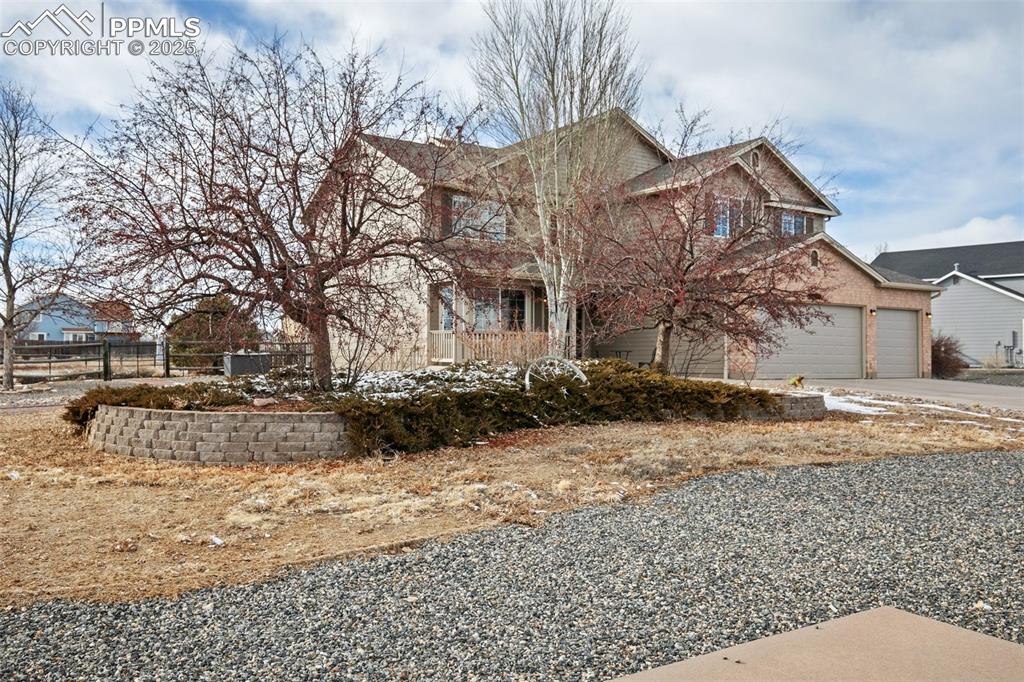8518 Bohleen Road Peyton, CO 80831 - Photo 3 of 44 a view of a white house with a yard covered in snow
