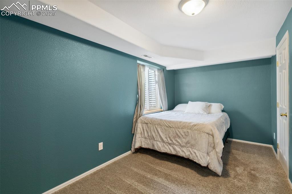 8518 Bohleen Road Peyton, CO 80831 - Photo 33 of 44 a bedroom with a bed and window