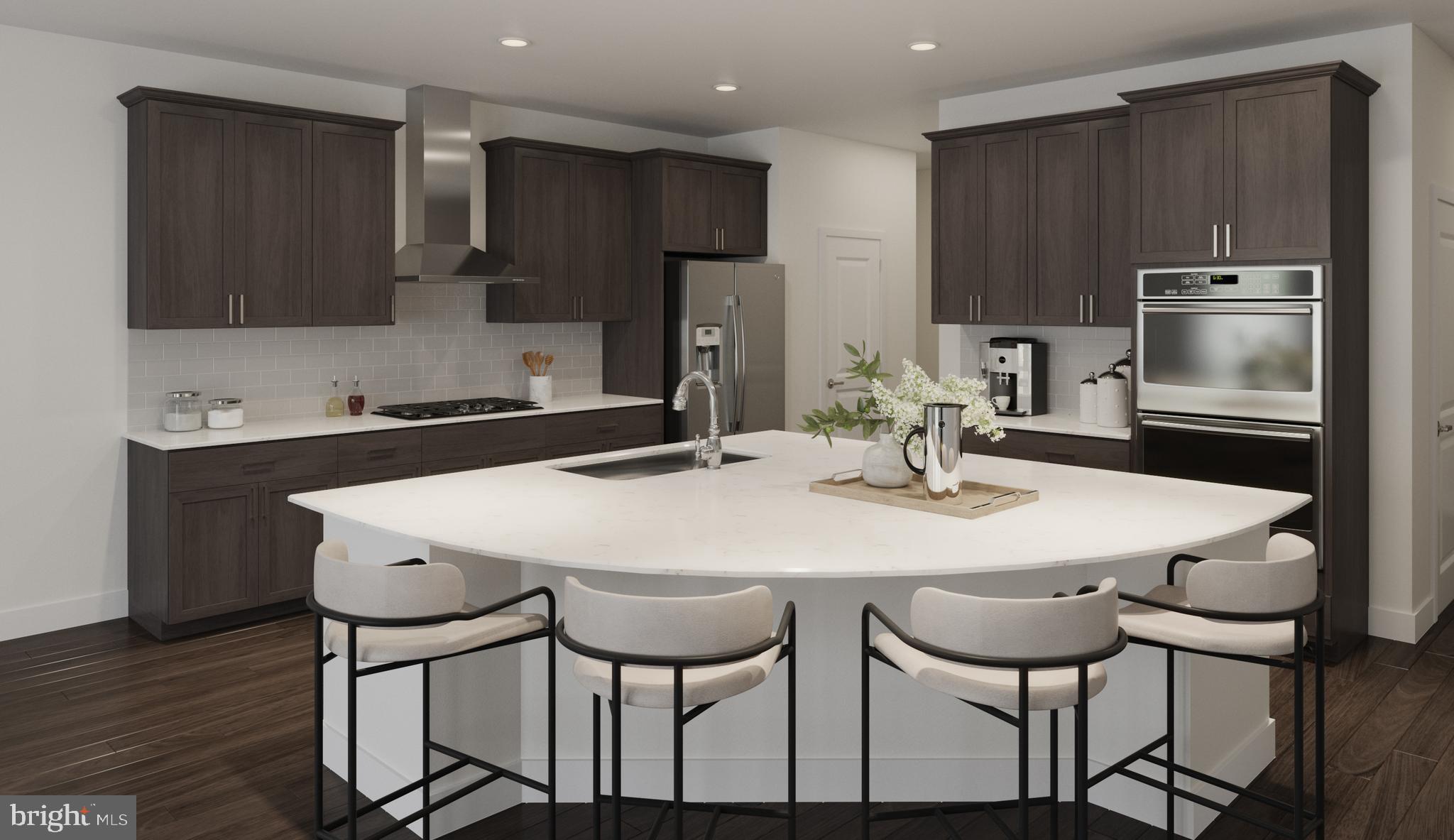 a kitchen with stainless steel appliances a dining table chairs and microwave