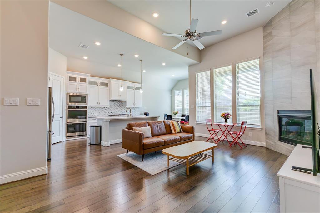 3920 Bentgrass Road Plano, TX 75023 - Photo 8 of 30 a living room with furniture flat screen tv and wooden floor