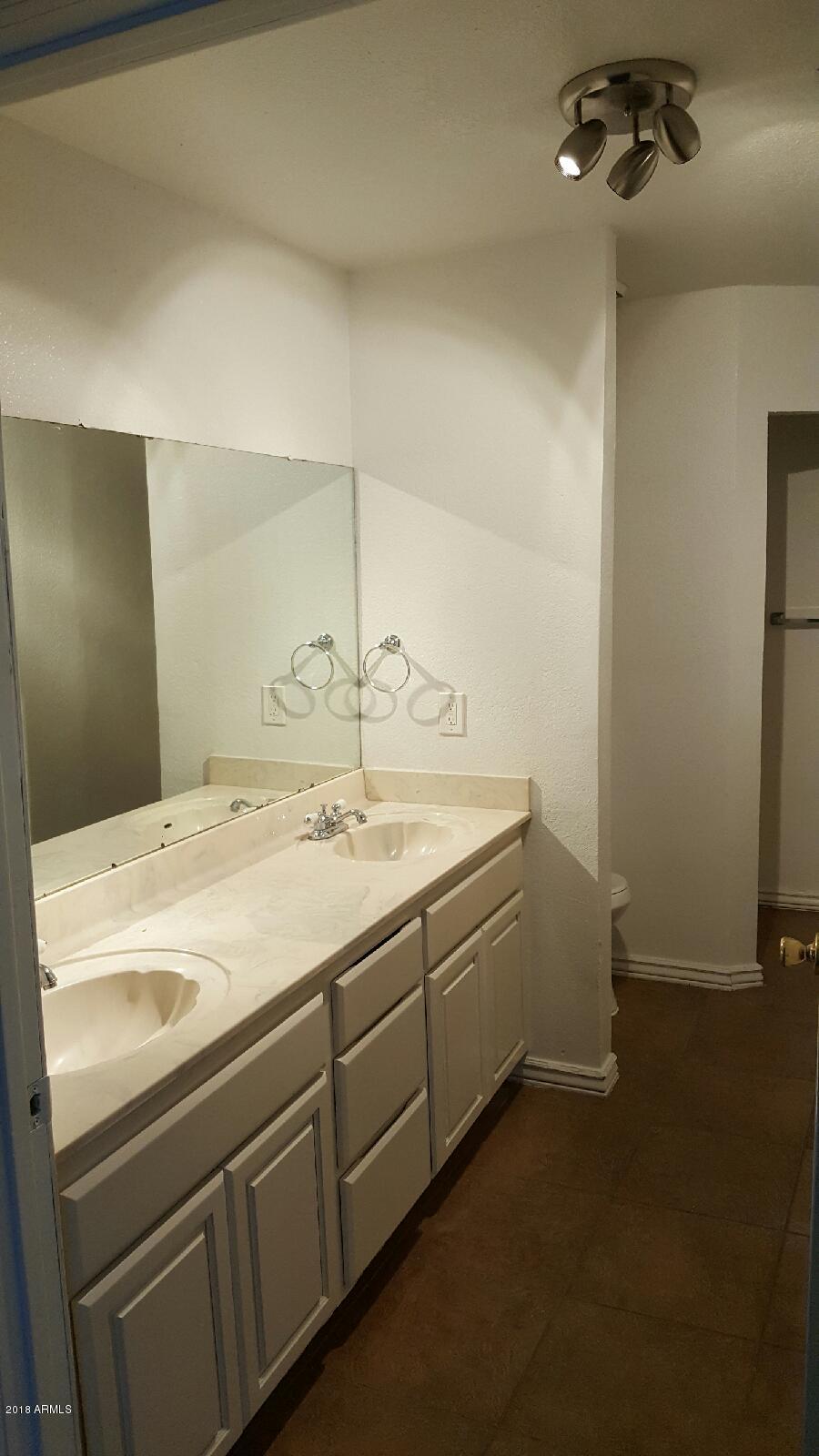 4123 West Osborn Road Phoenix, AZ 85019 - Photo 8 of 12 His/Hers bathroom