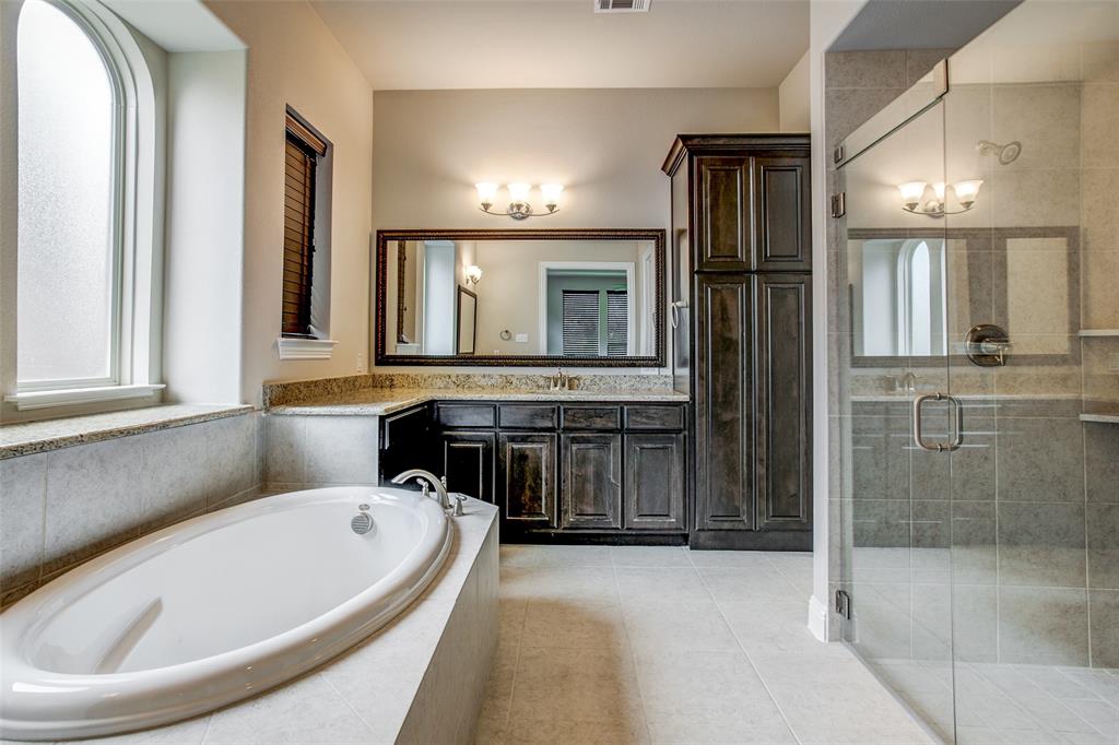 6810 Historic View Dallas, TX 75236 - Photo 8 of 12 a bathroom with a tub a double vanity sink and mirror