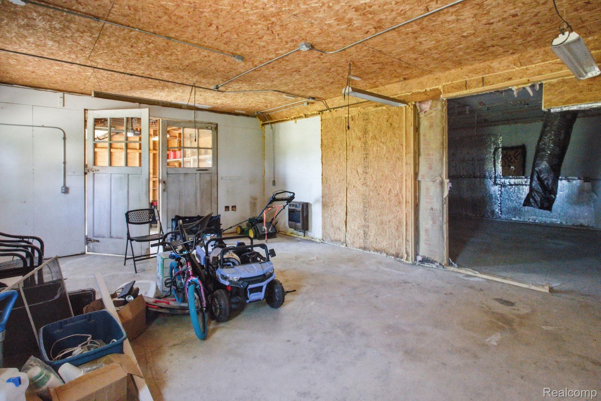 14104 Carleton West Road Carleton, MI 48117 - Photo 50 of 58 Miscellaneous room featuring unfinished concrete flooring and a garage